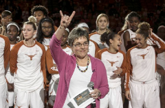 Chris Plonsky throwing up the Hook ‘Em Horns sign following the 1,000th all-time victory recorded by the Texas women’s basketball program.